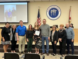 Kate Vitori with her school team and family at recent school board meeting after receiving recognition as a representative for the 2024 Sunshine State Scholar program. From left, Superintendent of Nassau Schools Kathy Burns, FBHS school counselor Sarah Coombs, mathematics instructor James Glackin, Vitori’s mother, Carrie Vitori, scholarship winner Kate Vitori, Vitori’s father, David Vitori, Vitori’s grandmother, Marlene Kozak, Vitori’s grandmother, Marsha Abernathy, grandfather, Bob Abernathy. Submitted 