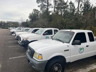 A long line of Nassau County fleet vehicles parked at the James S. Page Governmental Complex. In 2021, the county used 527,271 gallons of diesel or gasoline. Photo by Sean Mathew Rosenthal
