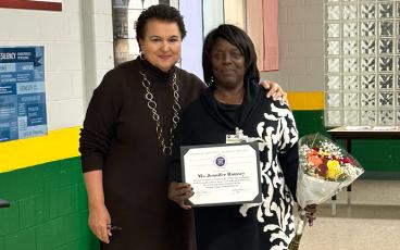 Nassau County School Superintendent Kathy Burns, left, presents Jennifer Ramsey with a special certificate for her heroic actions that saved a child's life. Submitted photo