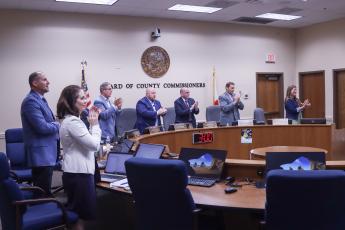 Commissioners give a standing ovation to one of the several people recognized at the Nassau County Board of County Commissioners meeting held Wednesday.  Photo by Ashley Chandler/News-Leader