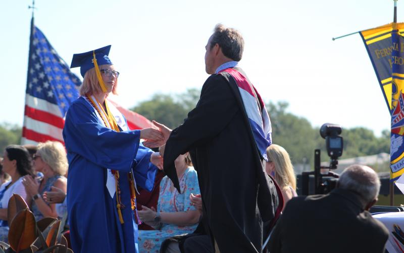 Valedictorian Kiawa Dempsey receives her diploma from Fernandina Beach High principal Chris Webber.