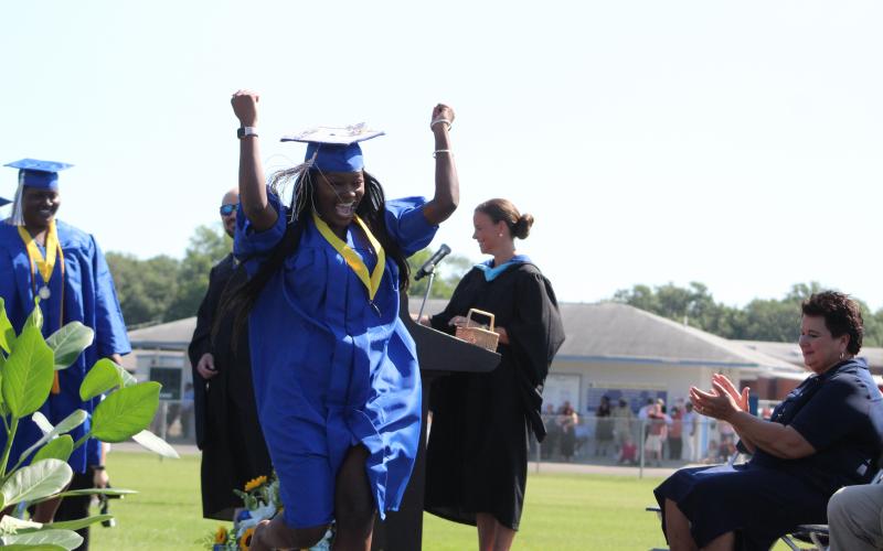 Fernandina Beach High graduate Maya Turner celebrates hearing her name being called before collecting her diploma.
