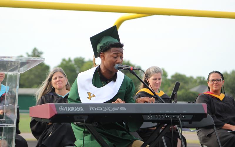 Yulee senior Braxton Gardner plays the keyboard and performs the alma mater Wednesday.