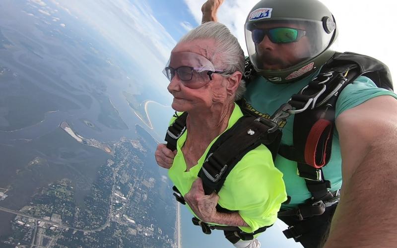 Ruby Coleman falls through the clouds at 125 mph with Skydive Amelia Island tandem instructor Gregory Meyer.