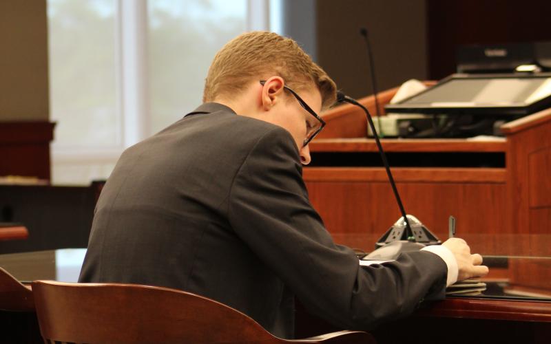 Fernandina Beach High School Senior Dillon Wagner prepares for court. Wagner volunteers his time as a prosecuting attorney for the State of Florida in Teen Court. Photo by Holly Dorman.