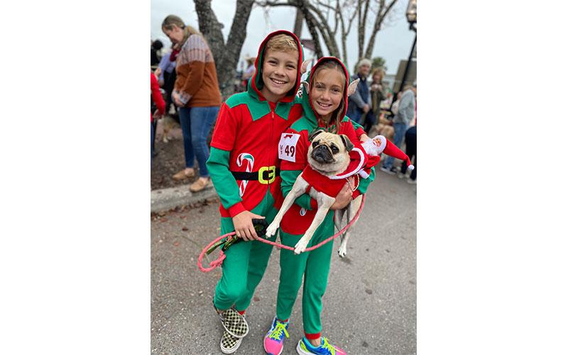 Wil and Harper McGinnis with Maizy the pug. Parade of Paws. Photo by Tracy Dishman