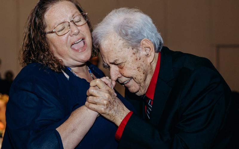 Larry Cochran, right, one of the honored seniors, and his caregiver, Nancy Chandler, dance to the music from Bold City Classics Band. Photo by Page Teahan Photography
