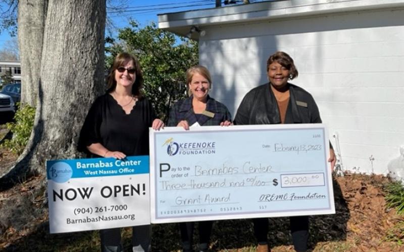 Ramona Jones, trustee with The Okefenoke Rural Electric Membership Corporation Foundation, presents a grant award to Barnabas Chief Development Officer Tania Yount and Callahan Office Empowerment Program Coordinator Joyce Knox. Submitted photo