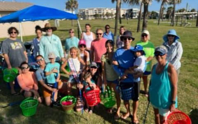 Only a portion of the more than 50 volunteers who showed up to help clean the beach on Saturday are pictured here. Submitted photo