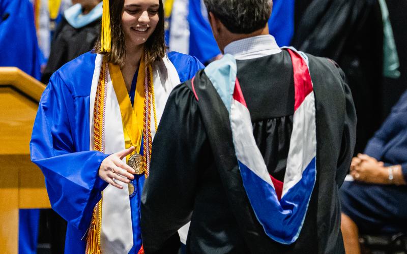 Fernandina Beach High School valedictorian Emmie Athavale walks across the stage to receive her diploma. Penny Glackin/News-Leader