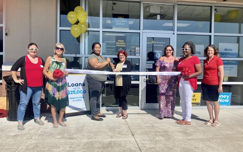 At the recent ribbon cutting ceremony for Advance America, holding the scissors is Lyntrell O’Neal, Center Sales Manager, left, and Jennifer Adkins, Consumer Lending Specialist. Submitted photo