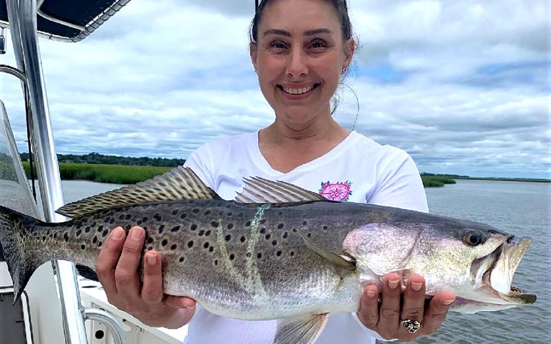 Stacey Jennings, above left, caught this beautiful 8-pound sea trout with her first cast, while fishing with Capt. Terry D. Lacoss.  Special photo