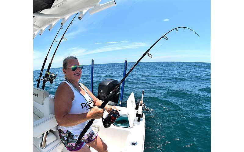 During FWC’s two-day red snapper season last year, Glenda Crosby’s snapper bait, left, had barely reached the bottom before a large Amelia Island red snapper took her bait.  Photo by Terry Lacoss/Special