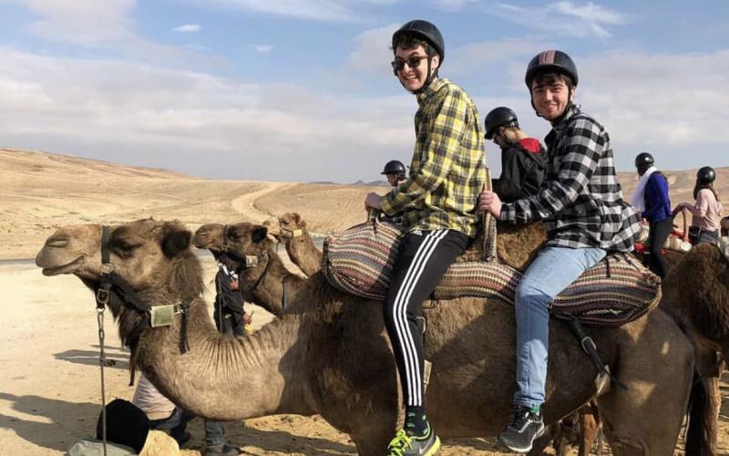 Sean Rosenthal (left) and friend Jake Schwartz (right) on a camel in the desert of Israel.  Photo by Sean Rosenthal/News-Leader