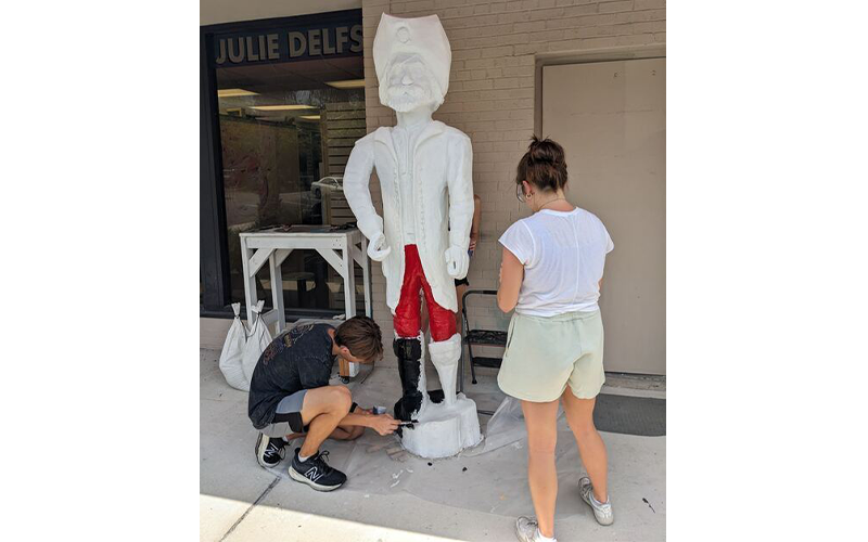 Left to right, local students Vincent Dracus and Coleman Hawkins paint new Peg Leg Pete. Submitted photo