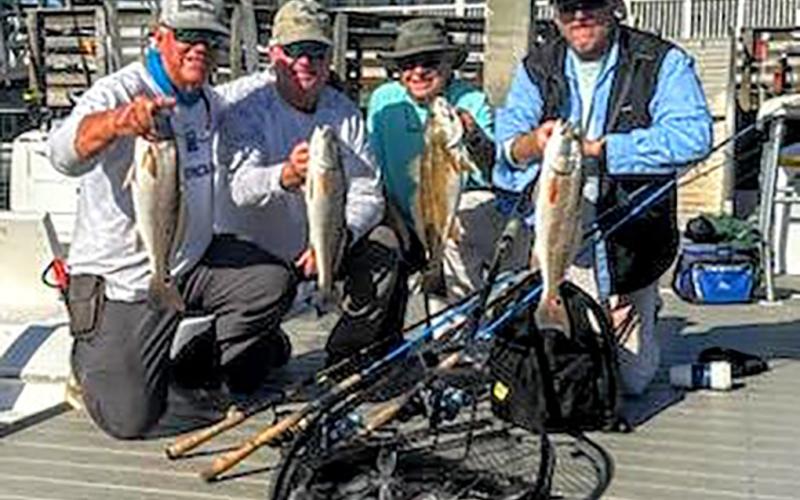 Terry Lacoss, Greg Cook, Jack Healan and Bill Fassbender, from left, are pictured with a limit catch of inshore redfish and off-shore black sea bass. Submitted photo