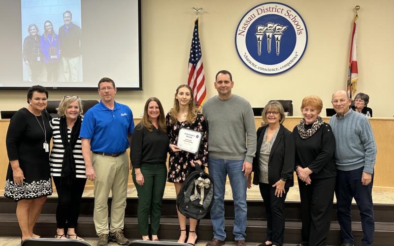 Kate Vitori with her school team and family at recent school board meeting after receiving recognition as a representative for the 2024 Sunshine State Scholar program. From left, Superintendent of Nassau Schools Kathy Burns, FBHS school counselor Sarah Coombs, mathematics instructor James Glackin, Vitori’s mother, Carrie Vitori, scholarship winner Kate Vitori, Vitori’s father, David Vitori, Vitori’s grandmother, Marlene Kozak, Vitori’s grandmother, Marsha Abernathy, grandfather, Bob Abernathy. Submitted 