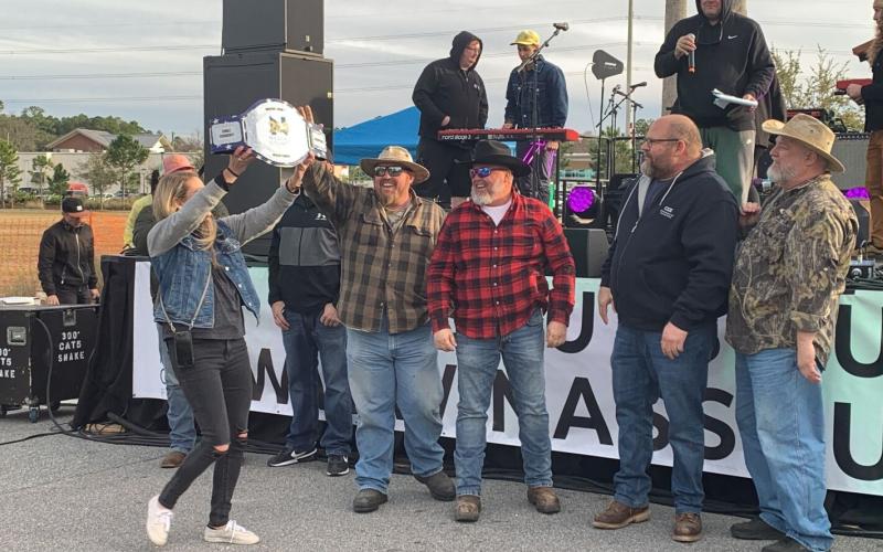 The Loggerheads team, from left, Commissioner Klynt Farmer, Wes “Cowboy” Watson, Brian Jahay and Joey Rehberg are presented with a trophy for winning the bicentennial chili cook-off event. Photo by Sabrina Robertson