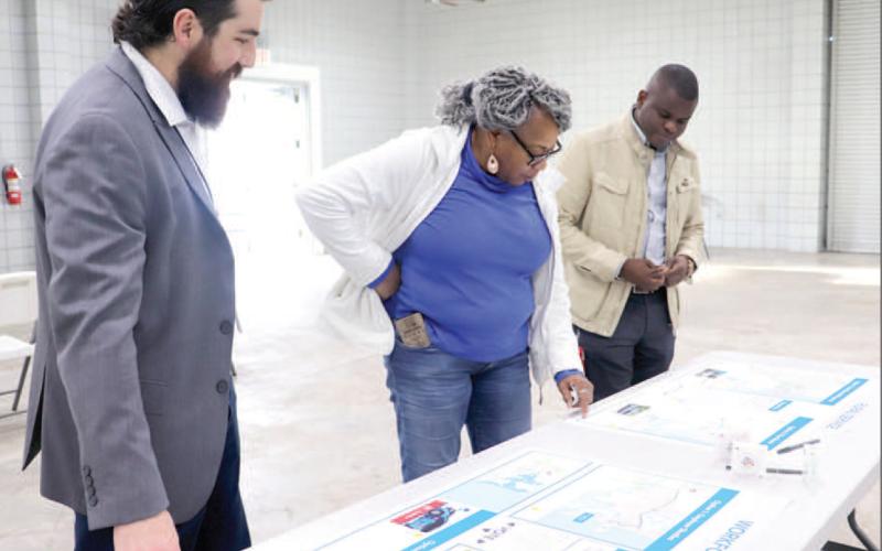Callahan resident Eleby Harris looks over proposed Jacksonville Transportation Authority plans that could provide bus service to western Nassau residents. She is joined by JTA Director of Planning and Sustainability Xan Traversa and another JTA representative. Photo by Kathie Sciullo/Community Newspapers
