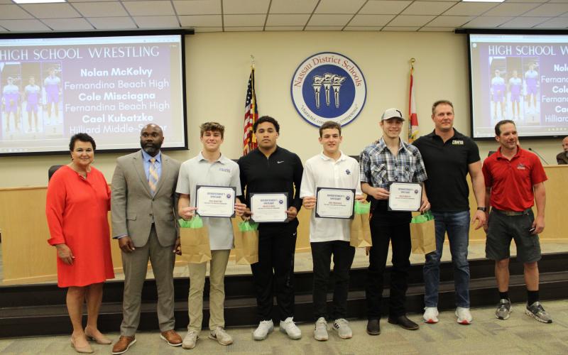 Student athletes were recognized for their accomplishments at the Florida high school boys state wrestling championships. From left, Kathy Burns, George Raysor, Cael Kubatzke, Braylen Ricks, Cole Misciagna, Nolan McKelvy, Eric Kubatzke and Jeremy Ferry. Photo by Tracy McCormick-Dishman/News-Leader
