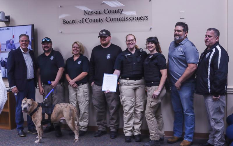 The Nassau County Board of County Commissioners proclaimed next week, April 14-20, as Animal Care and Control Appreciation Week in the county. Nassau County Animal Control staff brought a special guest with them to the meeting Monday.  Photo by Ashley Chandler/News-Leader