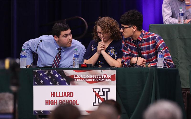 Hilliard High School team mates discuss the answer to a question. Photo by Ashley Chandler/News-Leader